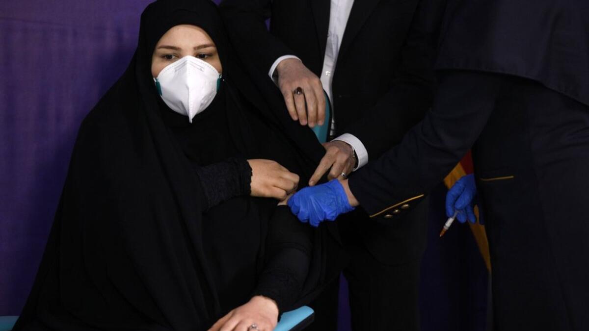 Tayebeh Mokhber is injected with the Coviran coronavirus vaccine produced by Shifa Pharmed, part of a state-owned pharmaceutical conglomerate, in a ceremony in Tehran, Iran, Tuesday, Dec. 29, 2020.