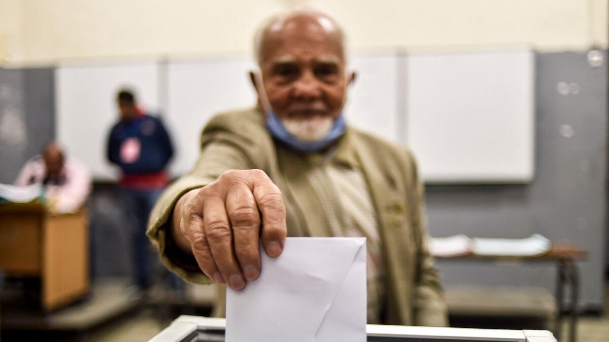 A man casts his vote just before polls close at a polling station in Algeria's capital Algiers on Sunday.