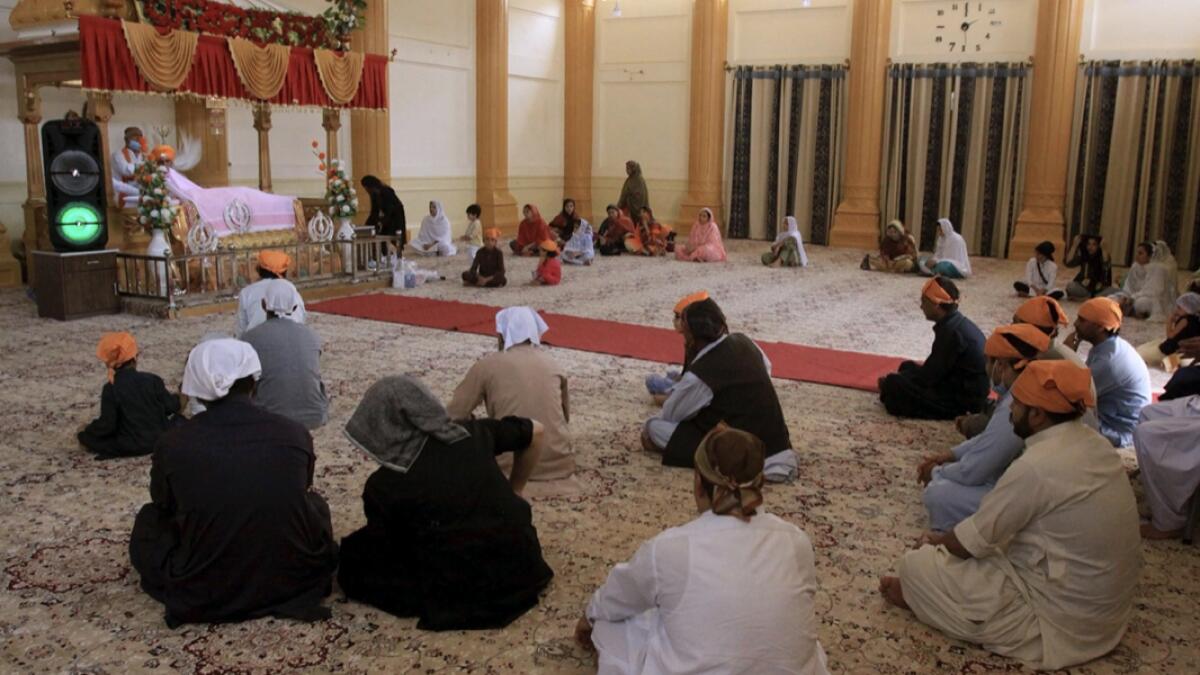 People of Sikh Community take part in a worship at Gurudawara Sri Guru Singh Sabha temple in Quetta, Pakistan. A 200-year-old Sikh temple that served as a school for Muslim girls for seven decades was returned to the Sikh community in the city of Quetta, enabling them to worship there for the first time in 73 years. Photo: AP