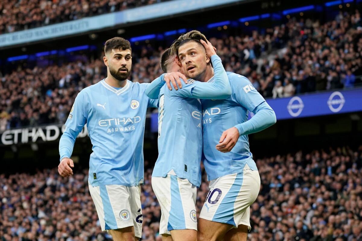 Manchester City's Jack Grealish (right) celebrates with Phil Foden after scoring a goal against Crystal Palace. — AP