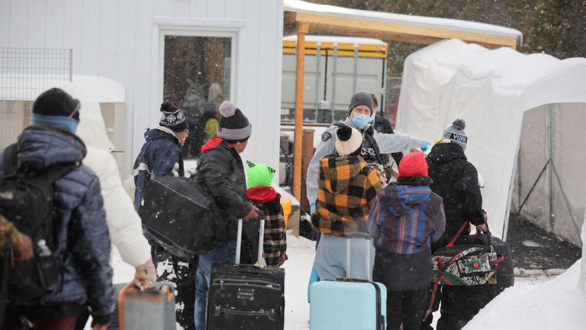 Asylum seekers, who state they are from Guatemala, cross into Canada from the US in Champlain, New York. — Reuters file