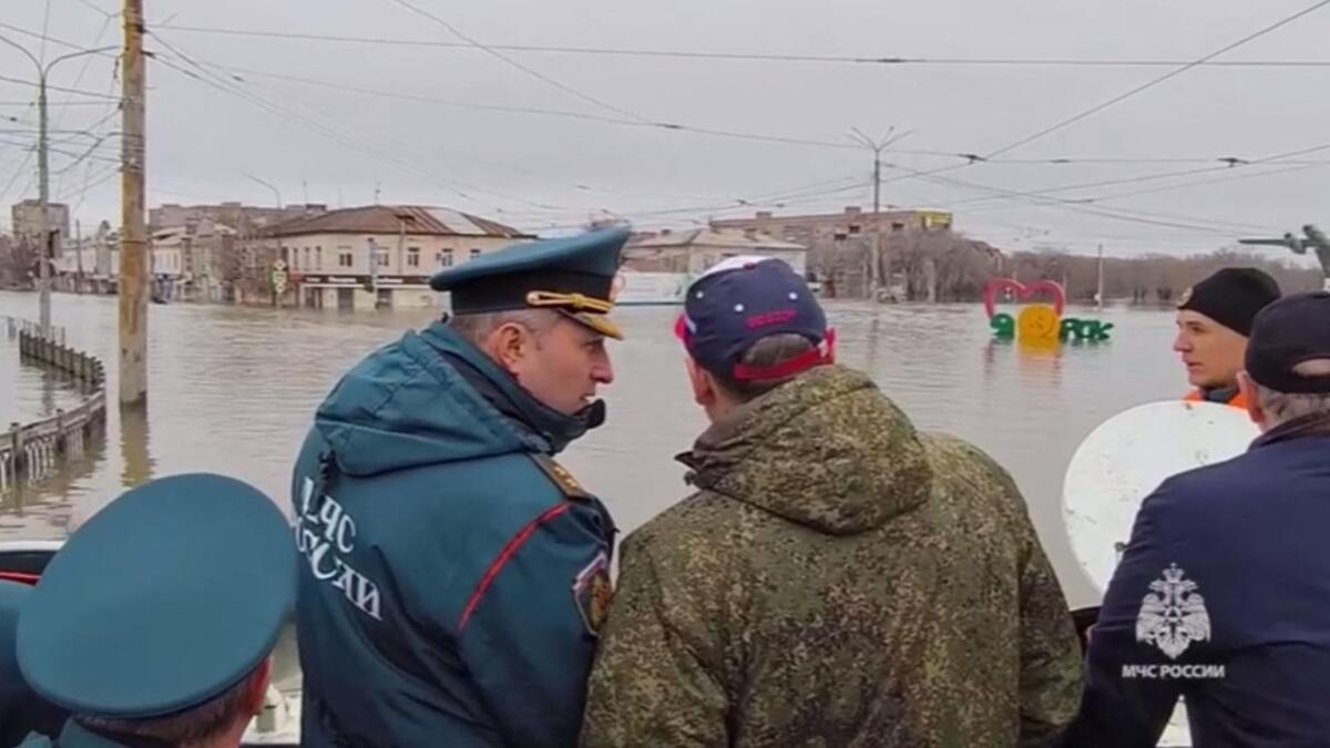 This photo taken from a video released by the Russian Emergency Situations Ministry on Sunday shows rescuers inspecting a flooded area in the town of Orsk, Orenburg region, southeast of the southern tip of the Ural Mountains. — AFP