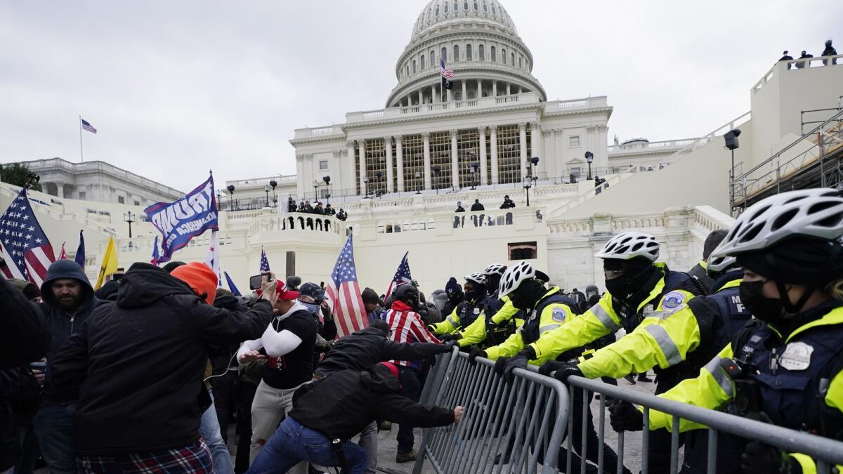 Insurrectionists loyal to Donald Trump try to break through a police barrier on January 6, 2021, at the Capitol in Washington. — AP file