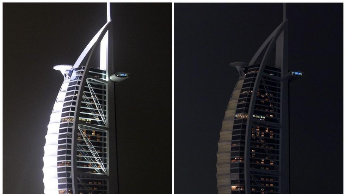  A combination of pictures shows a view of the Burj al Arab hotel of Dubai before (L) and during Earth Hour. 