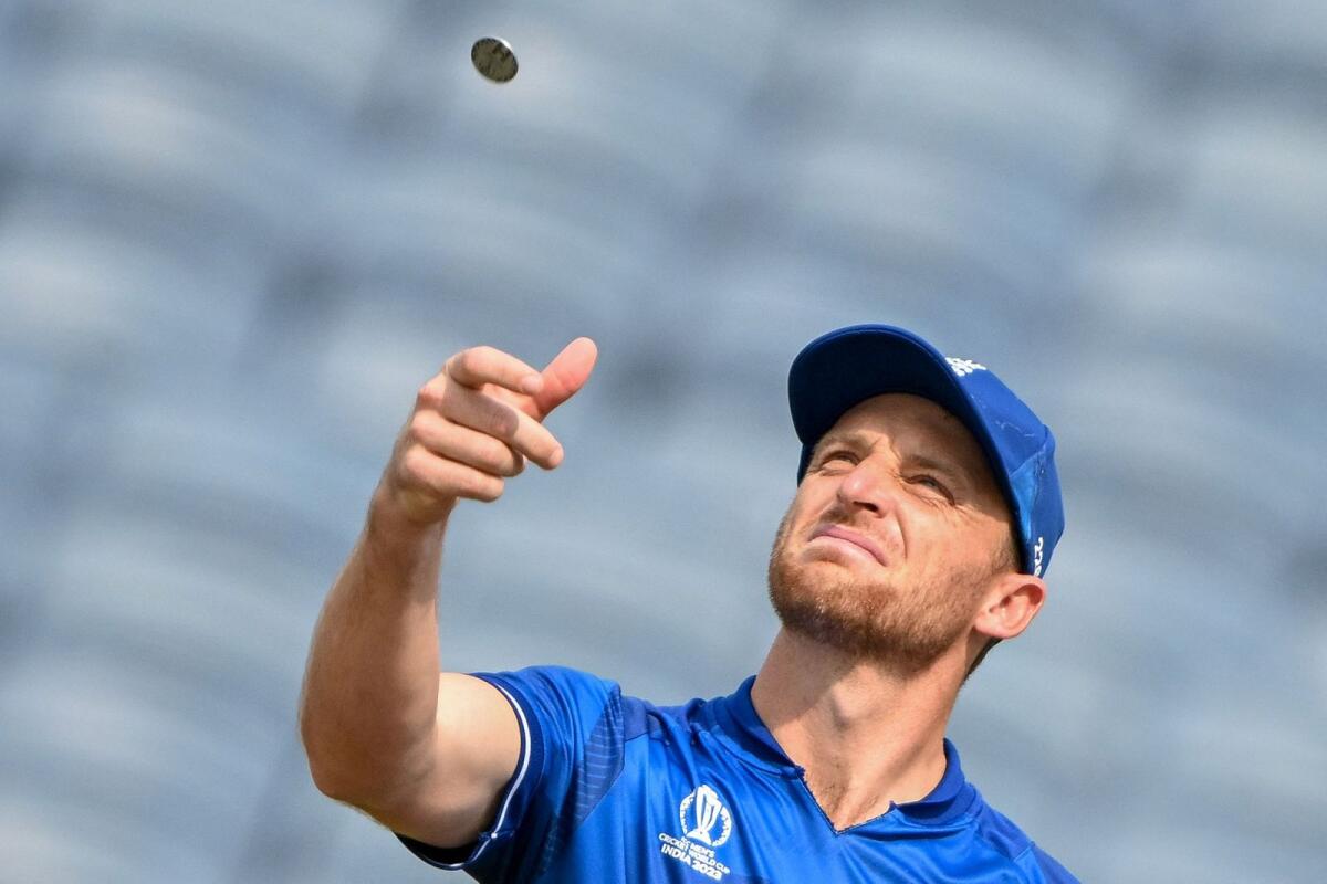 England captain Jos Buttler tosses the coin before the start of the match against the Netherlands in Pune on Wednesday. — AFP