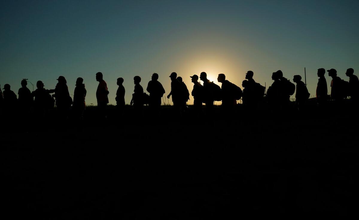 Migrants who crossed the Rio Grande and entered the US from Mexico are lined up for processing by US Customs and Border Protection on Sept. 23, 2023, in Eagle Pass, Texas.  — AP file