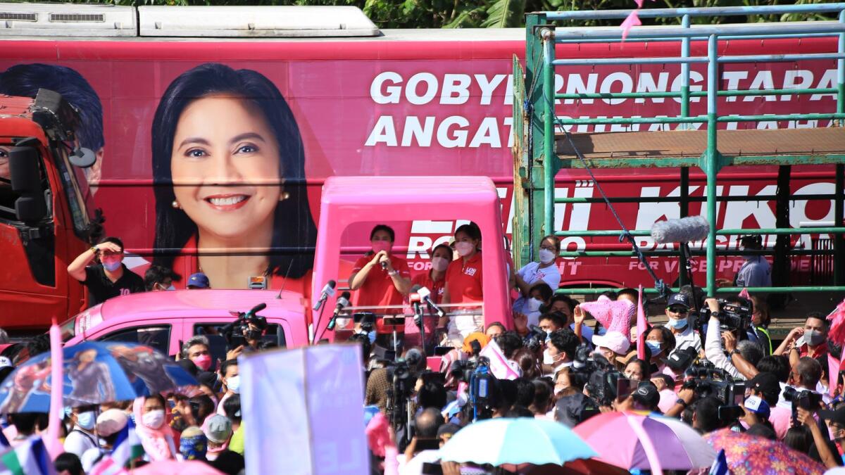 Philippine Vice President and opposition presidential candidate Leni Robredo (C-with microphone) speaks from a truck during a campaign rally in the town of Libamanan, Camarines Sur province, south of Manila on February 8, 2022, as candidates hit the road for the start of the three-month long campaign season. (Photo: AFP)