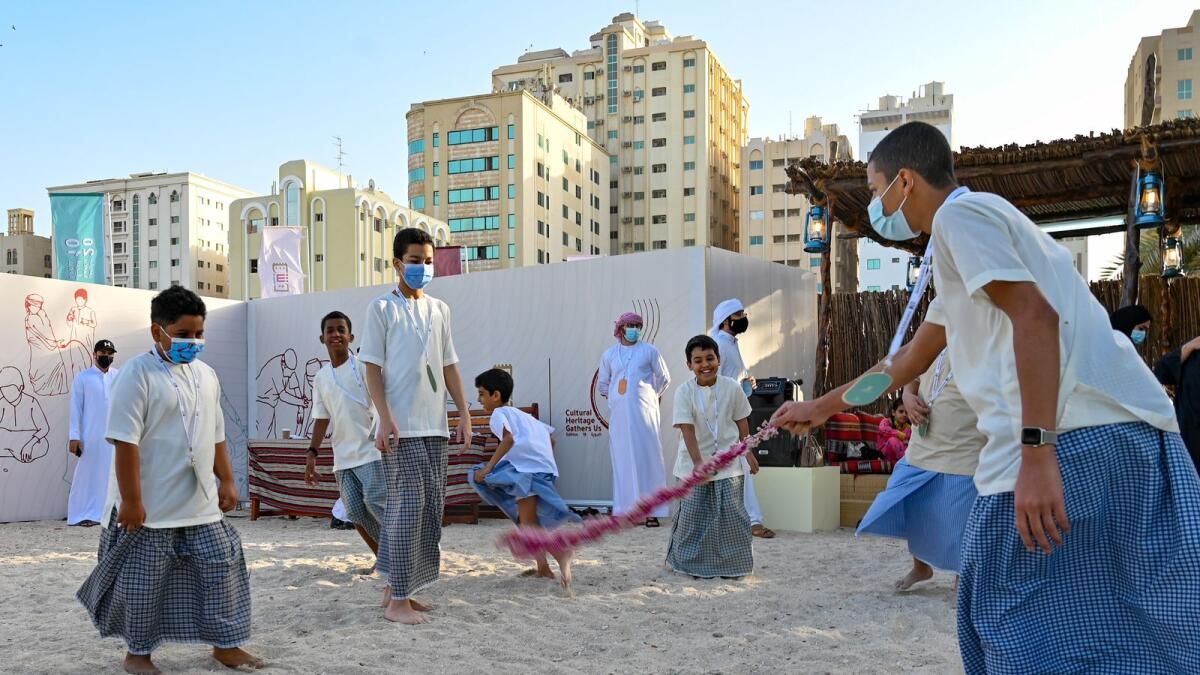 Emirati kids playing their traditional games.