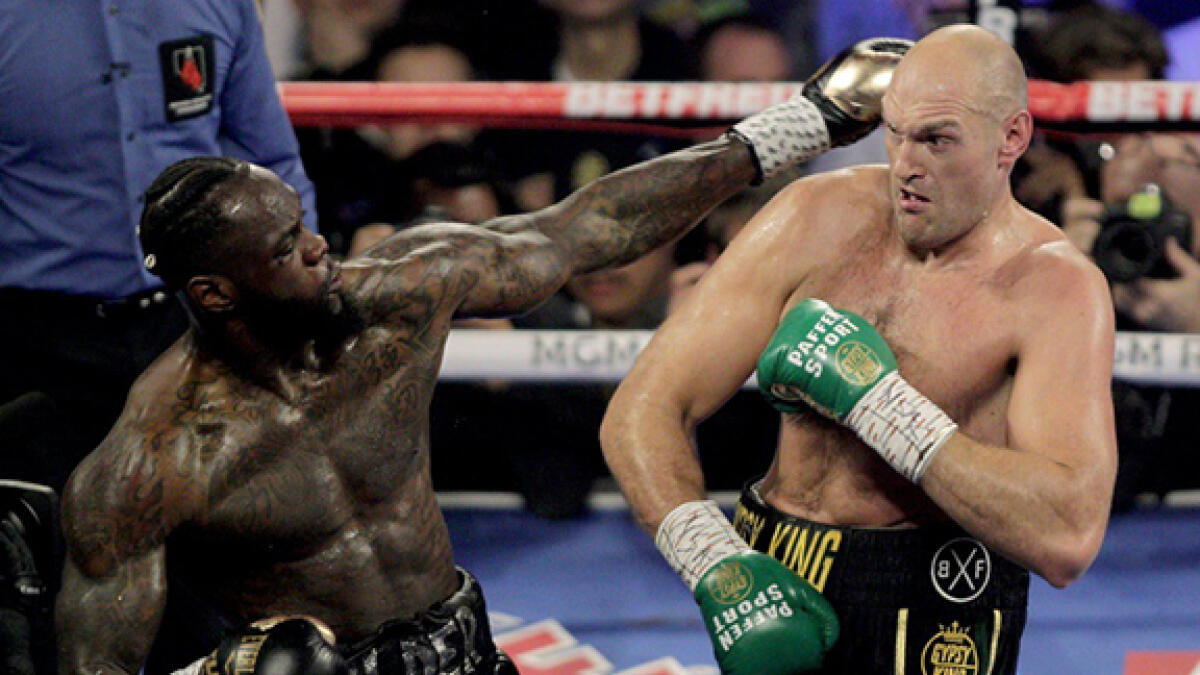 Tyson Fury (right) beat Deontay Wilder in their second fight in February. -- AFP