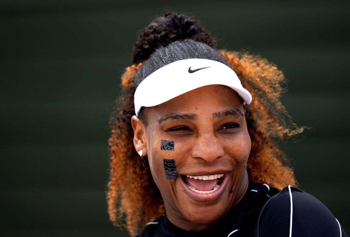 Serena Williams smiles during a training session at the All England Lawn Tennis and Croquet Club, Wimbledon, London, on Saturday. (AP)