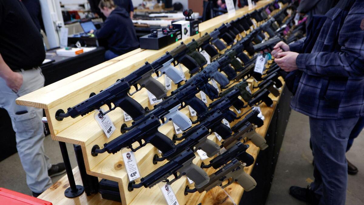 Customers shop for handguns at a gun show in Des Moines, Iowa. — Reuters file