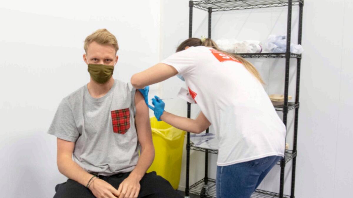 A man receives a dose of a Covid-19 vaccine at a mass vaccination centre in Arsenal's Emirates Stadium in north London. — AP
