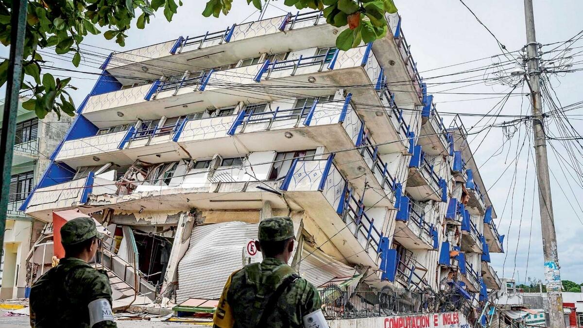 Soldiers stand guard a few metres away from the Sensacion hotel which collapsed with the powerful earthquake that struck Mexico overnight, in Matias Romero, Oaxaca State. — AFP