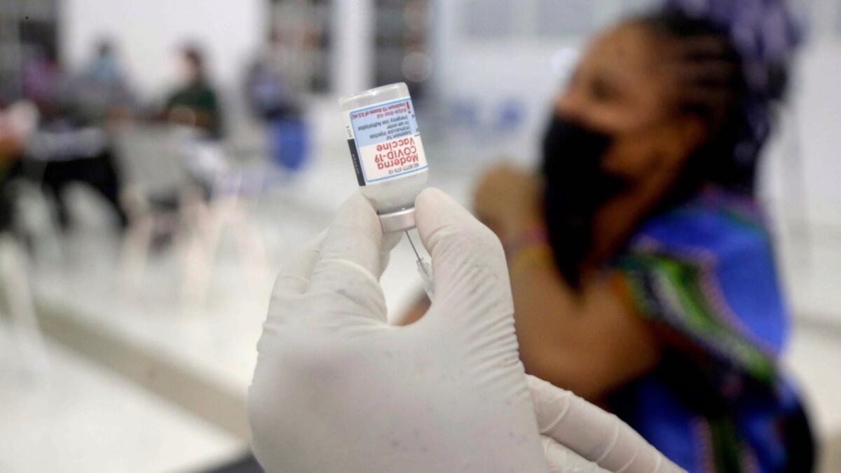 A nurse prepares the Moderna coronavirus vaccine at the health center in Lagos, Nigeria. — AP file