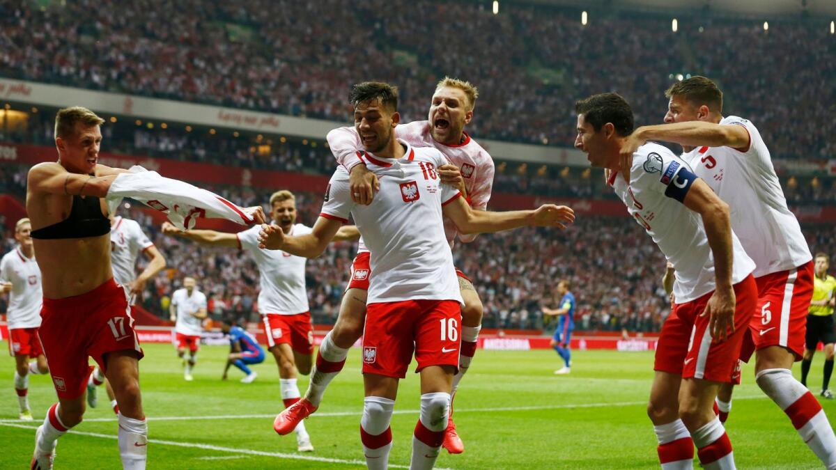 Poland's Damian Szymanski celebrates his goal with teammates. (Reuters)