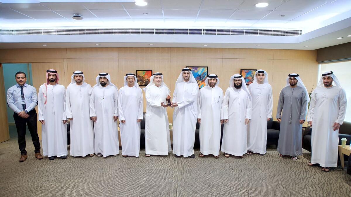 Saif Mohammed Al Midfa, CEO of ECS; Muammar Al Rukhaimi, CEO of ESH; and a number of officials photographed after the meeting in Sharjah. — Supplied photo