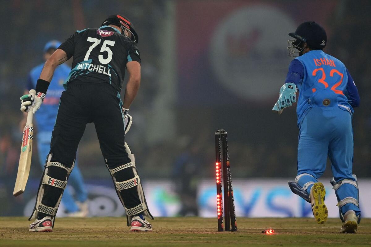 New Zealand's Daryl Mitchell (left) is clean bowled as India's wicketkeeper Ishan Kishan looks on during the second Twenty20 international in Lucknow. — AFP