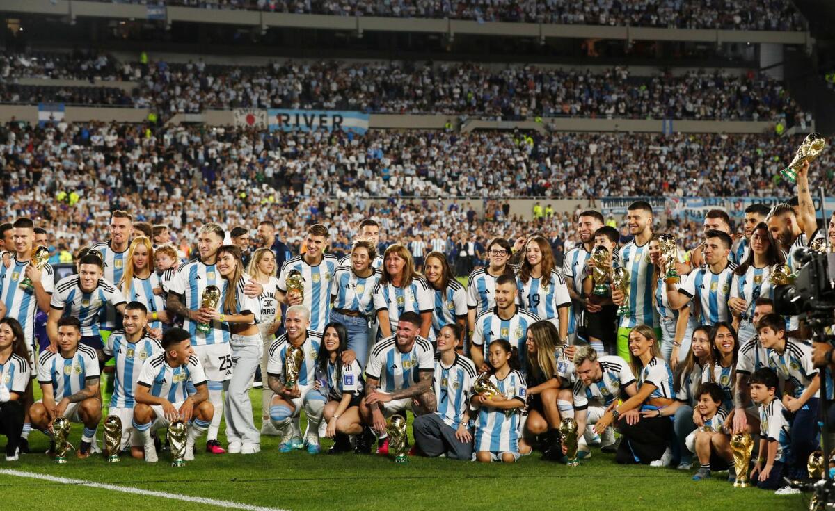 Lionel Messi and teammates pose with their families. — Reuters