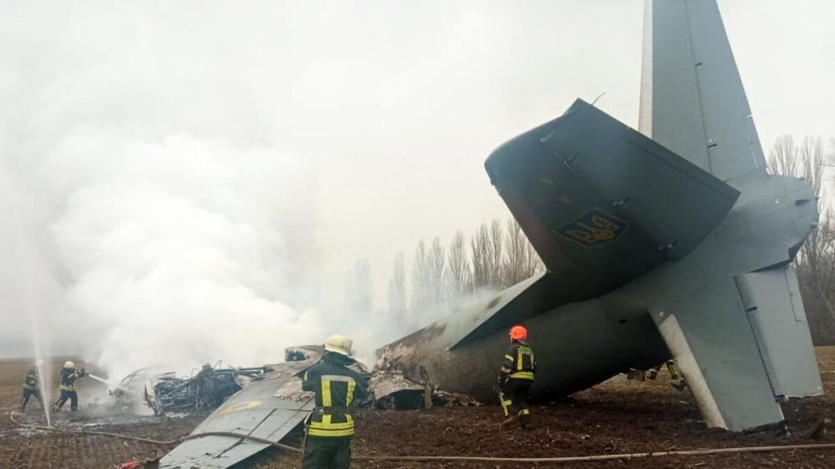 Emergencies personnel work at the crash site of a Ukrainian military plane south of Kyiv on February 24, 2022. Photo: AFP