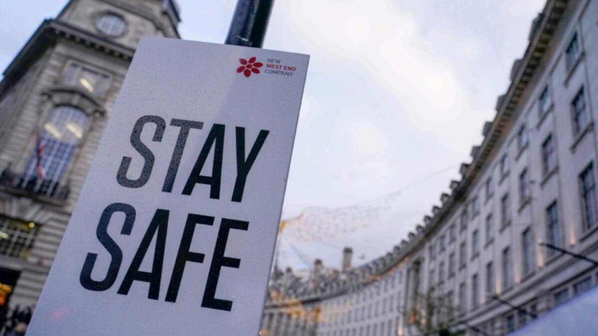 A sign reading 'Stay safe' in Regent Street, London. — AP