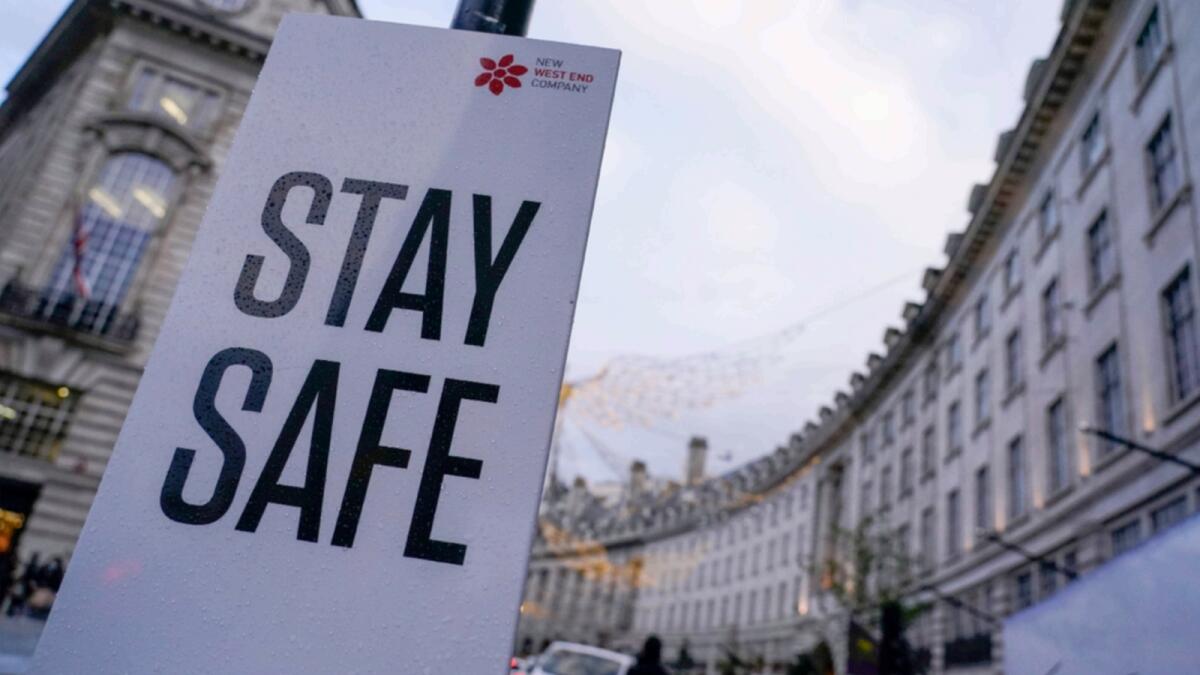 A sign reading 'Stay safe' in Regent Street, London. — AP