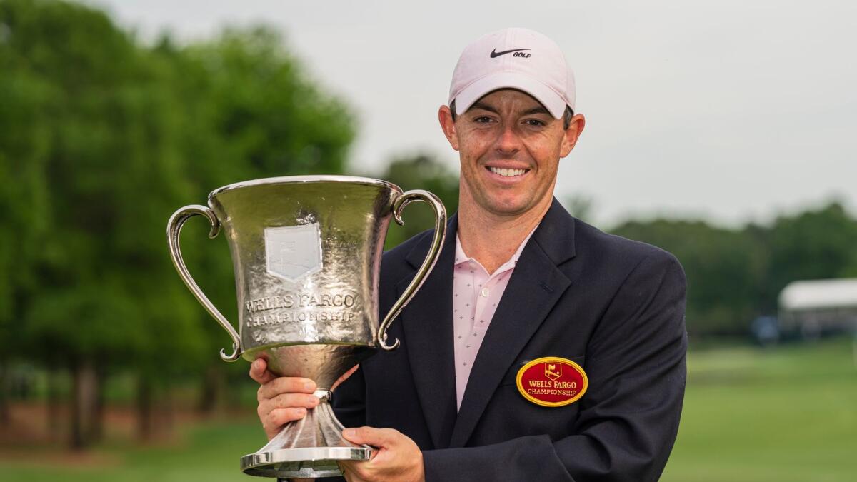 Rory McIlroy holds the trophy after winning during the fourth round of the Wells Fargo Championship golf tournament at Quail Hollow. — AP