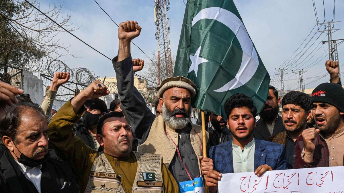People chant slogans at a protest against militancy and a suicide blast inside a police headquarters in Peshawar on February 1, 2023. — AFP file