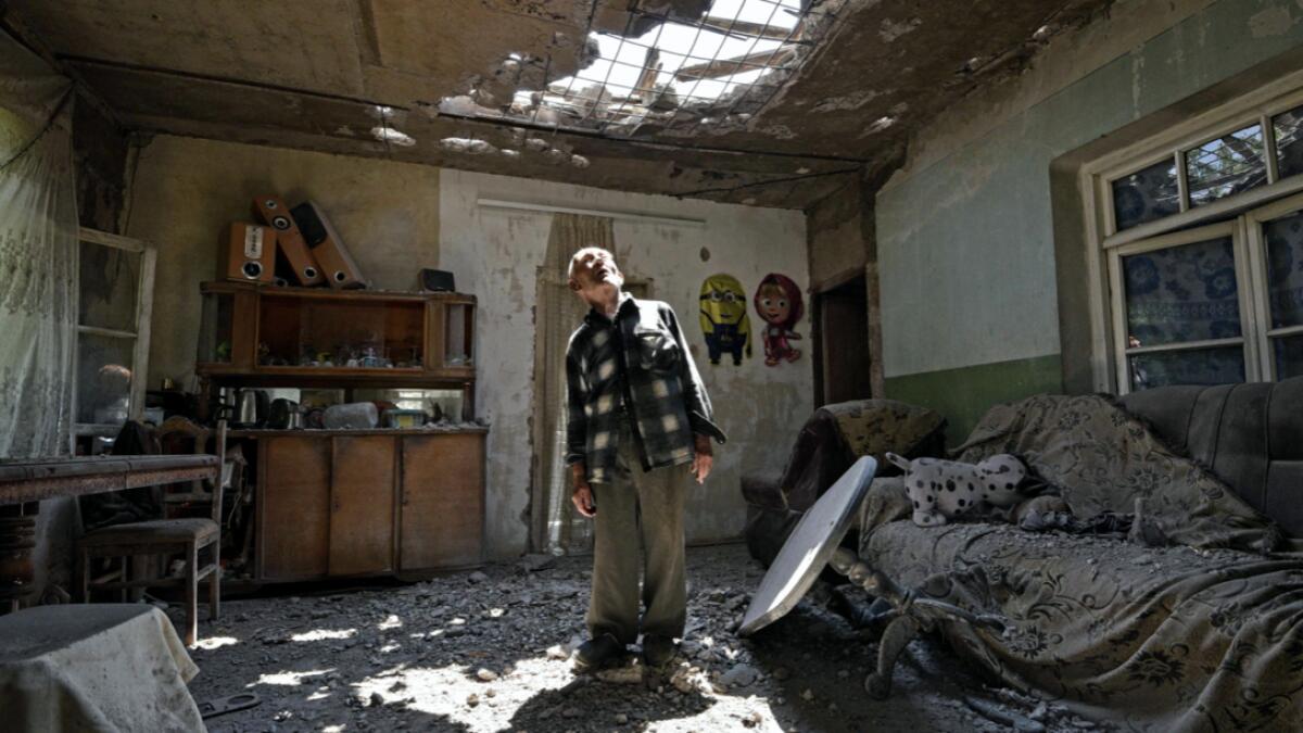 Aram Vardazaryan stands inside his home which suffered of bombing attacks on July 18, 2020, in the village of Aygepar, Tavush region, recently damaged by shelling during armed clashes on the Armenian-Azerbaijani border. Russia said, it is prepared to mediate peace talks between ex-Soviet rivals Armenia and Azerbaijan after fighting escalated along their shared border. Photo: AFP