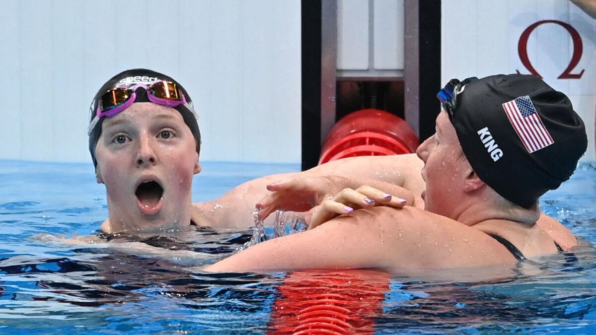 USA's Lydia Jacoby (left) reacts after winning the women's 100m breaststroke swimming final. (AFP)