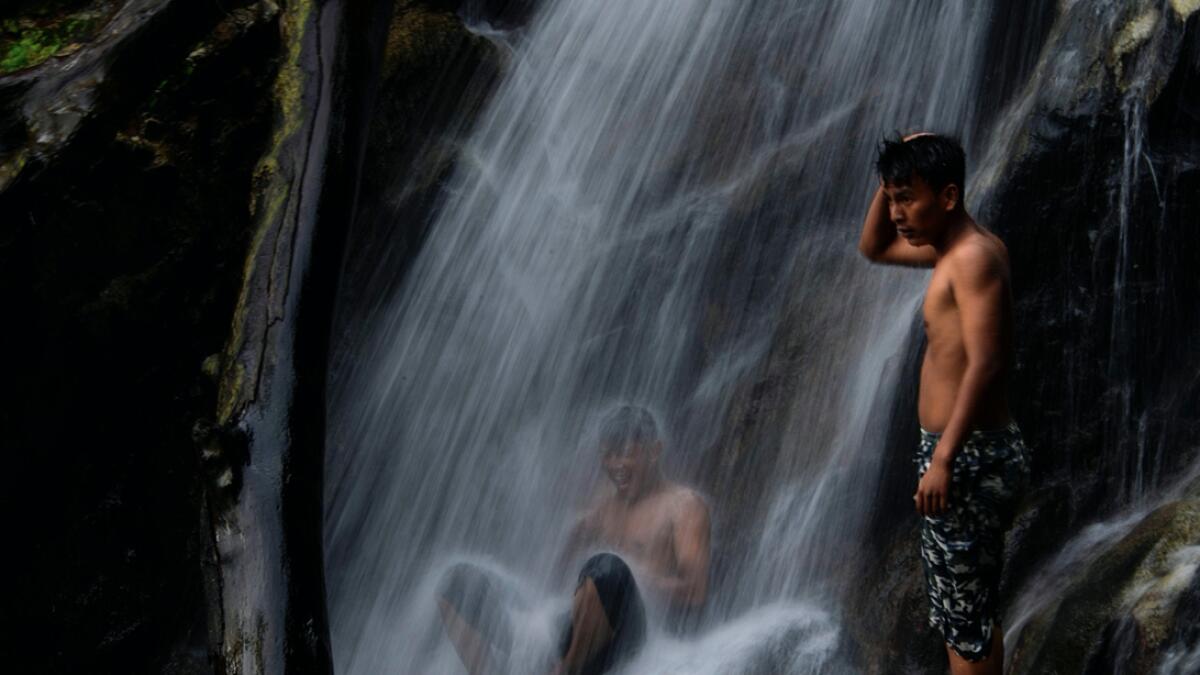Youths cool off at a waterfall in Samadua of Aceh Province, Indonesia. Photo: AFP