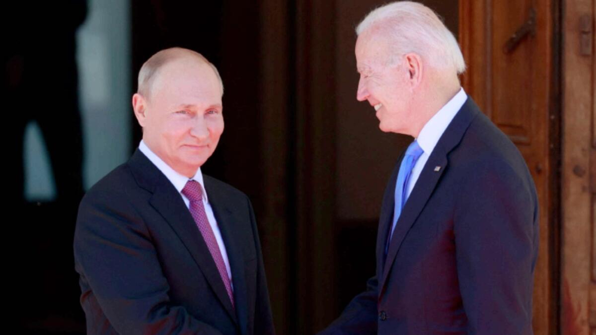 Russian President Vladimir Putin (L) shakes hands with US President Joe Biden prior to their meeting at the 'Villa la Grange' in Geneva. – AFP