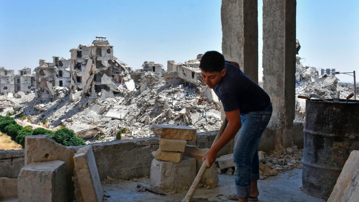 A Syrian labourer works as residents reconstruct their damaged homes in Al Zahraa neighbourhood of Aleppo following years of conflict. Photo: AFP
