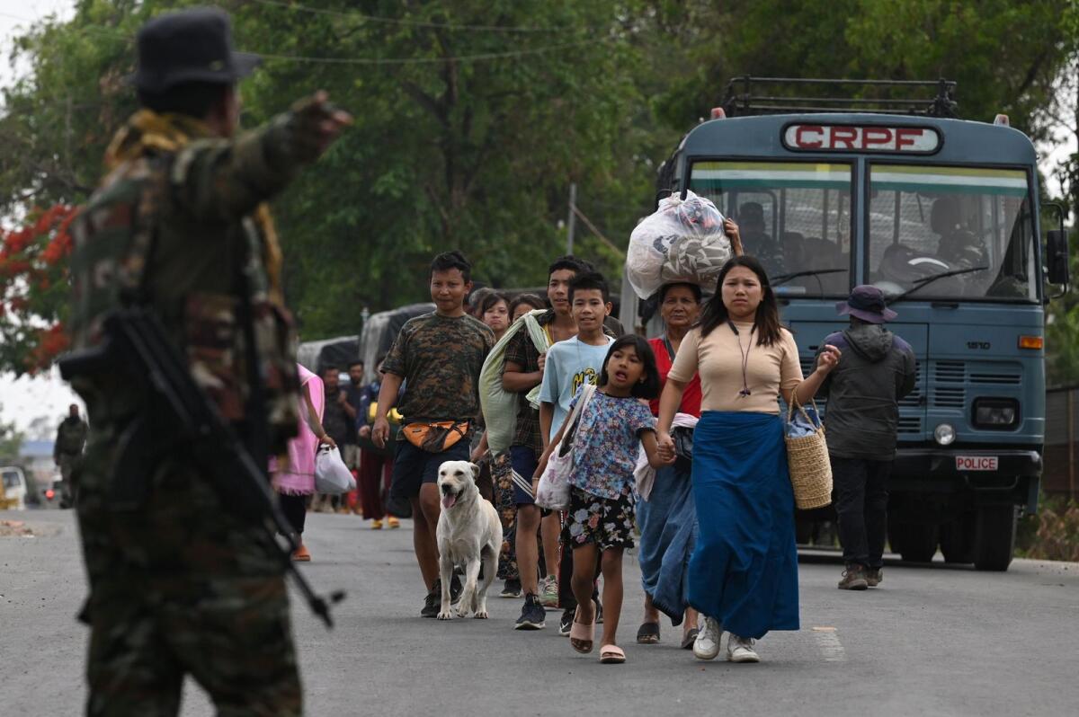 Meitei refugees arrive to board a paramilitary truck at a transit point after being evacuated from the violence that hit Churachandpur, near Imphal in the northeastern Indian state of Manipur on May 9, 2023. Photo: AFP