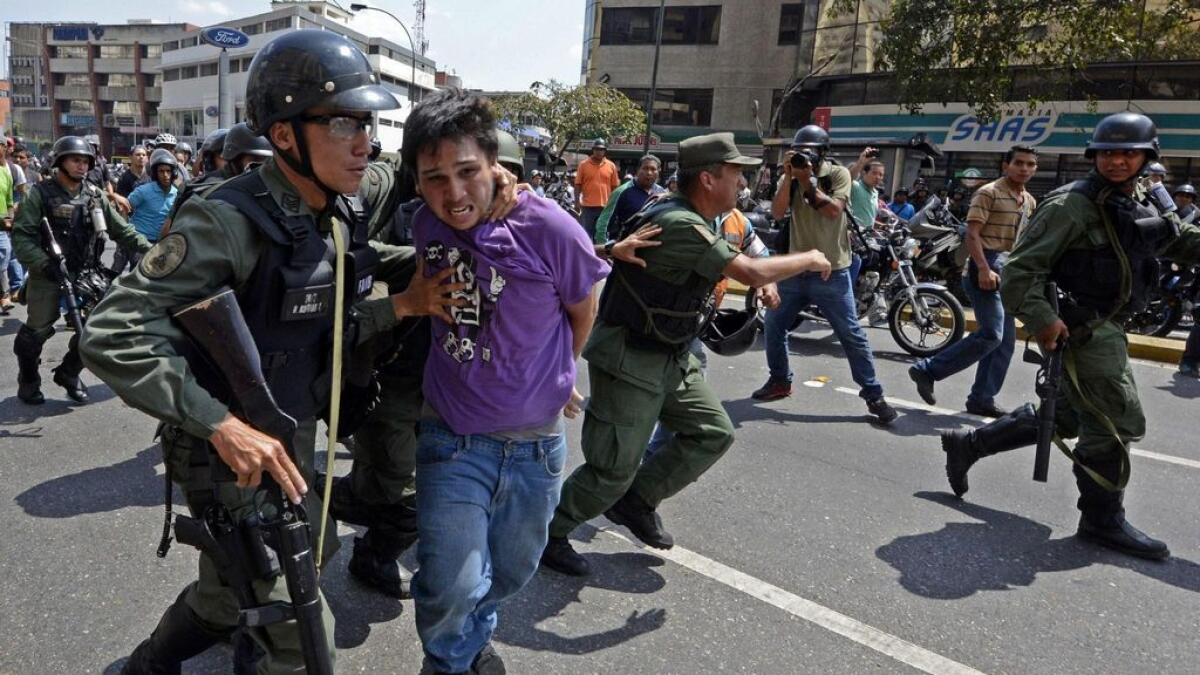 Protester arrested in Caracas, Venezuela.