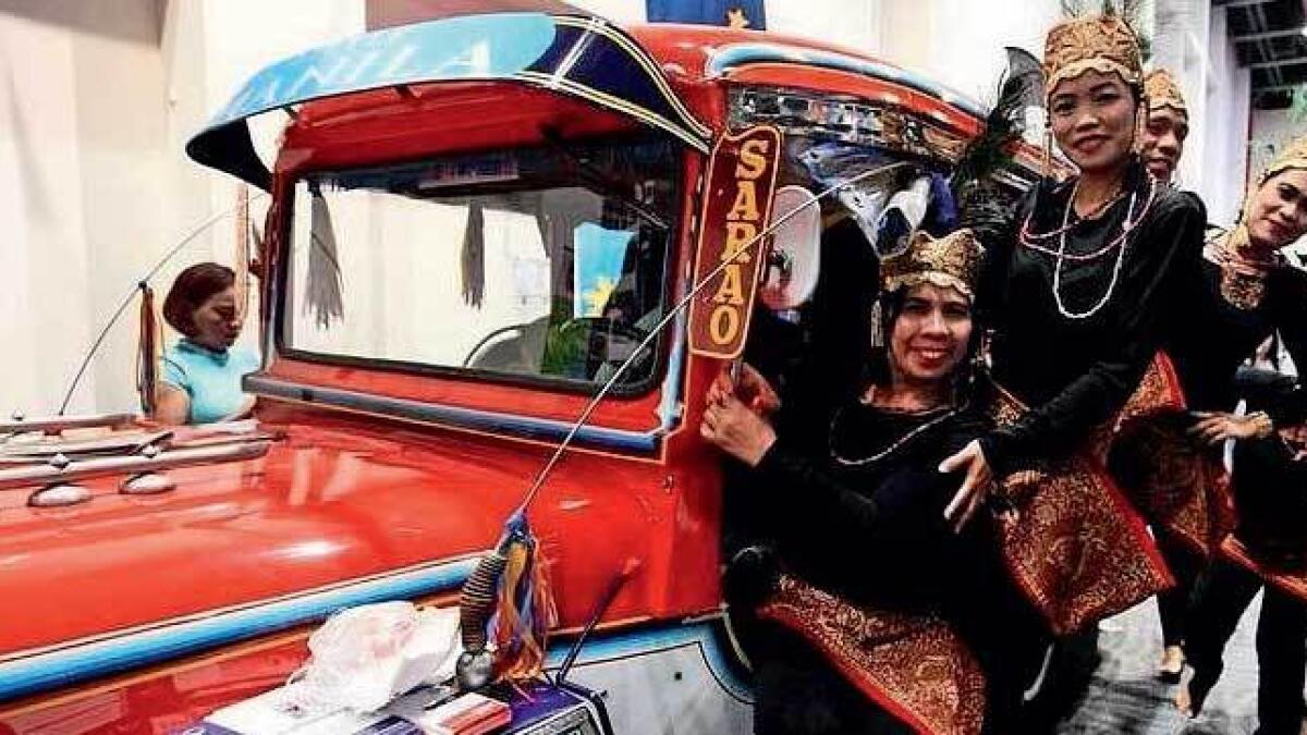 Performers in a jeepney, a symbol of Filipino pop culture, during the Bayanihan Festival last year. — File photo