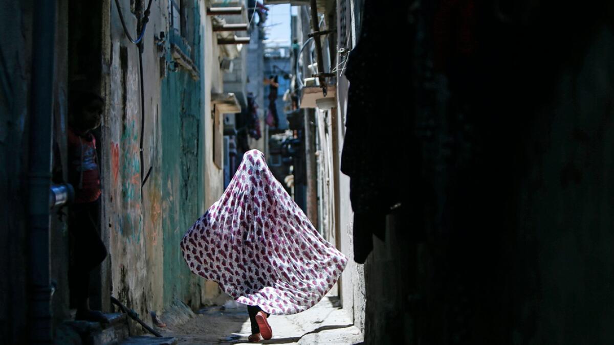 A Palestinian girl walks at the al-Shati refugee camp in Gaza City. Photo: AFP