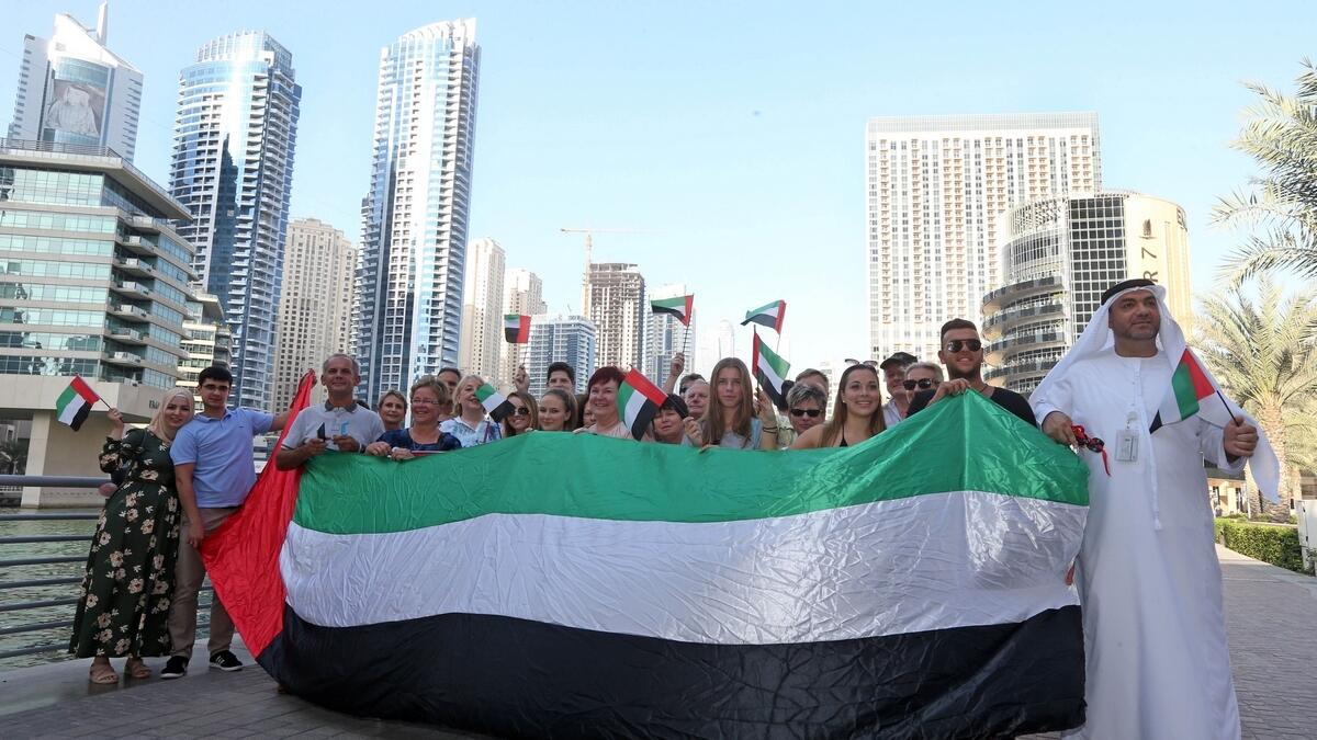 Tourists wave the UAE flag with pride, too