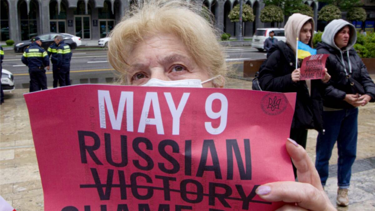 A demonstrator holds a poster during an anti-war protest against Russia in Tbilisi. — AP