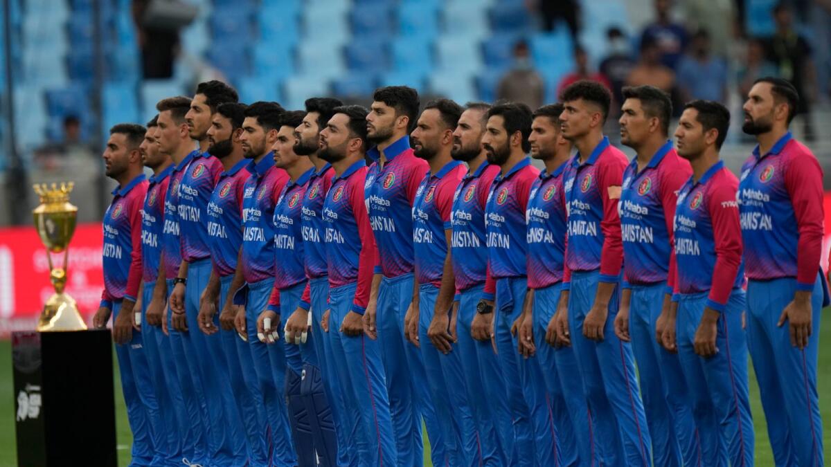 Afghanistan players stand for their national anthem before the start of the match against India. — AP