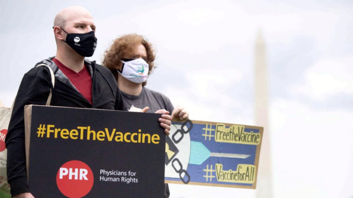 Demonstrators hold a rally to 'Free the Vaccine,' calling on the US to commit to a global coronavirus vaccination plan that includes sharing vaccine formulas with the world to help ensure that every nation has access to a vaccine. — AFP