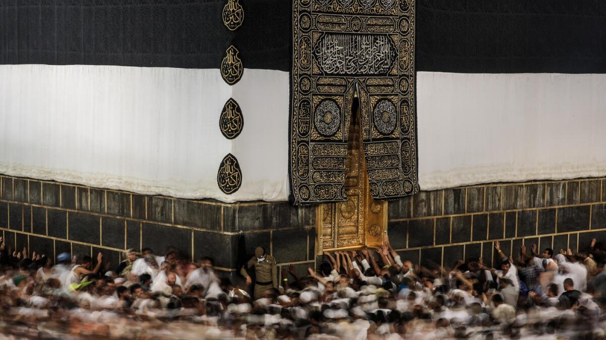 In this Monday, Sept. 21, 2015 photo taken with a slow shutter speed, Muslim pilgrims circle the Kaaba, the cubic building at the Grand Mosque in the Muslim holy city of Makkah. (AP Photo)