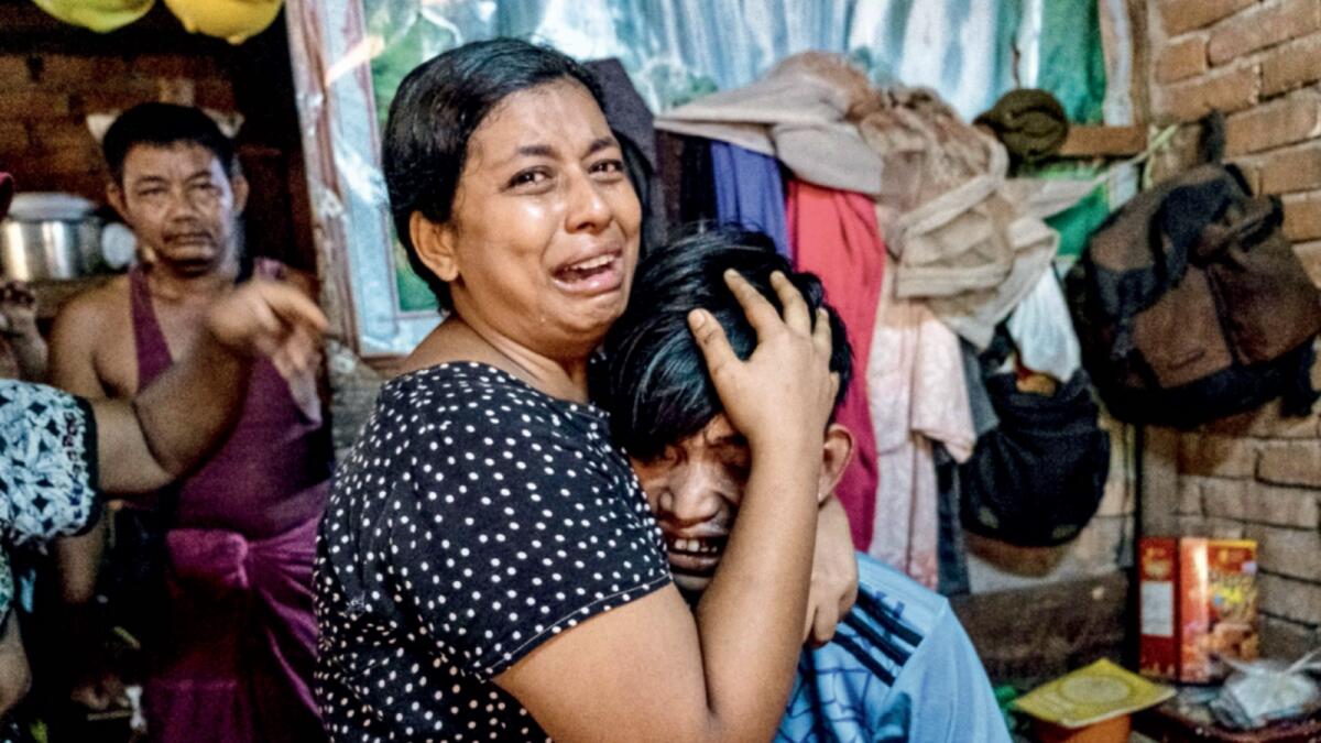 Family members cry after a man was shot dead during an anti-coup protesters crackdown in Yangon. — Reuters
