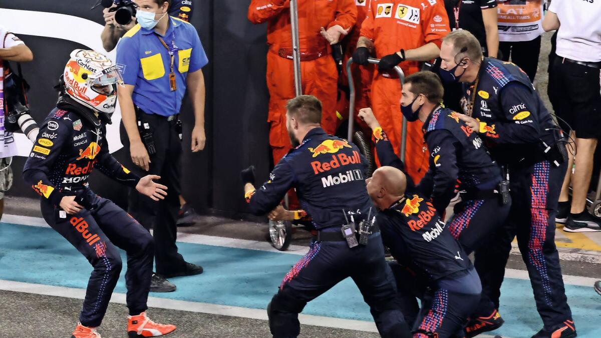Unbridled joy: Red Bull driver Max Verstappen celebrates with members of his team after winning the world championship at the Abu Dhabi Grand Prix on Sunday. — AFP