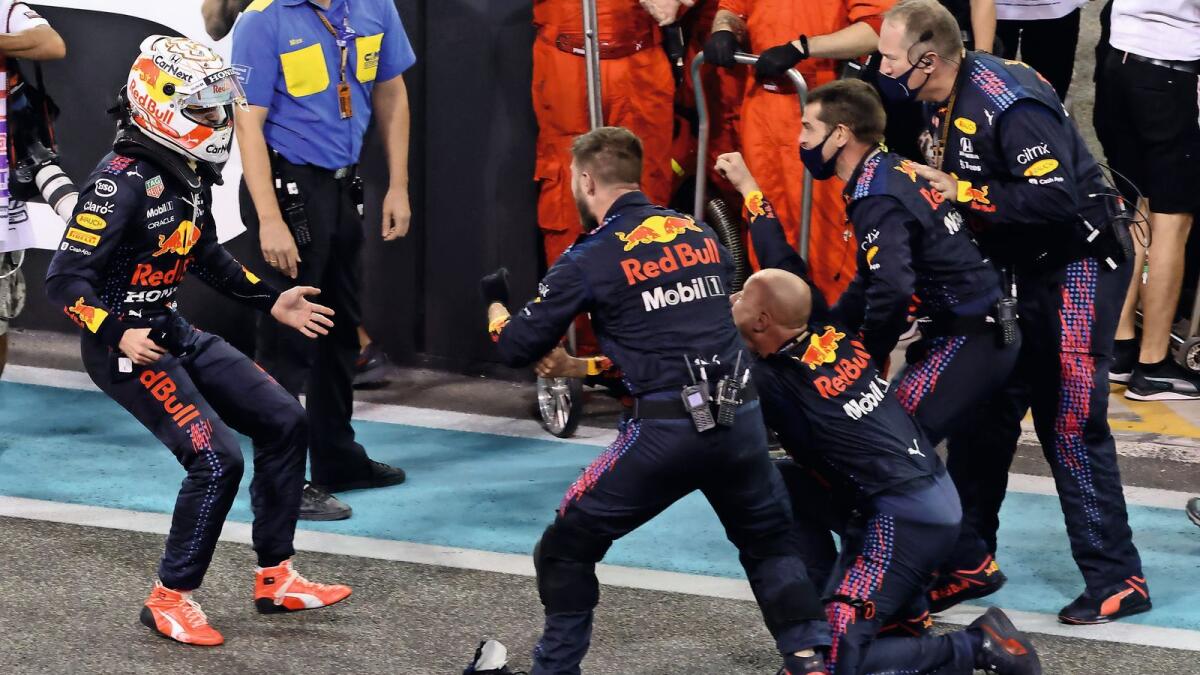 Unbridled joy: Red Bull driver Max Verstappen celebrates with members of his team after winning the world championship at the Abu Dhabi Grand Prix on Sunday. — AFP