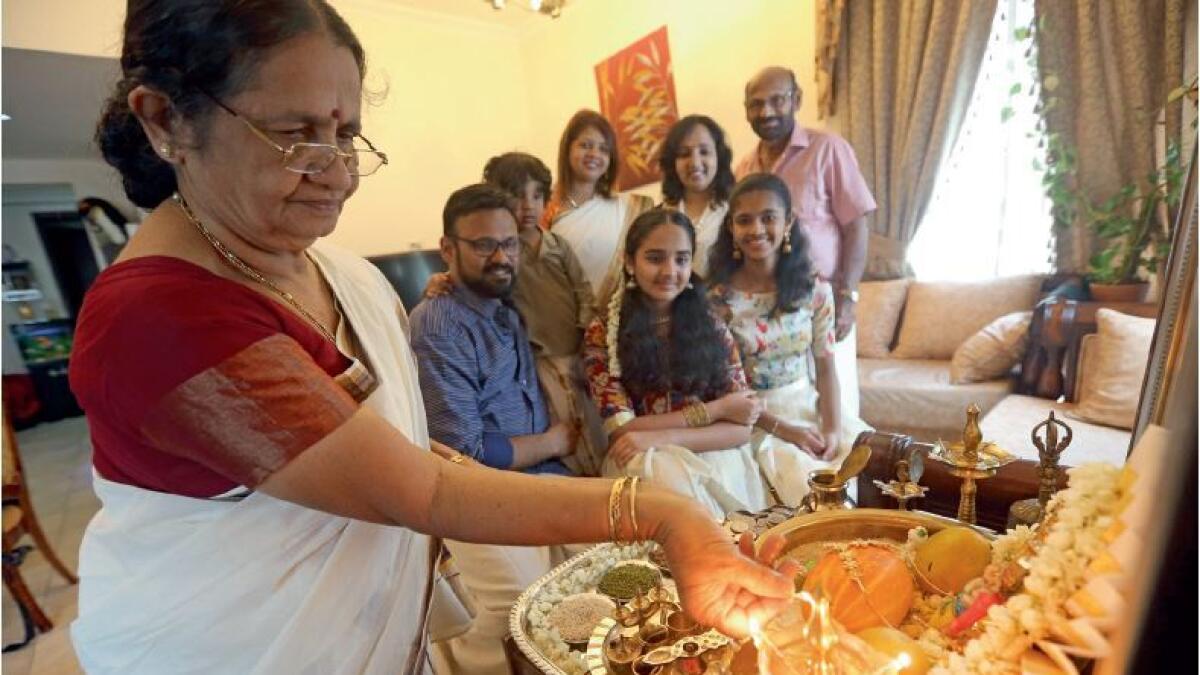 Arun Kumar Krishna and his family celebrate Vishu at their residence in Dubai on Saturday. The traditional festivities include  ‘kani’ or the first auspicious sight of the day early morning and a sumptuous feast in the afternoon. — Photo by Dhes Handumon