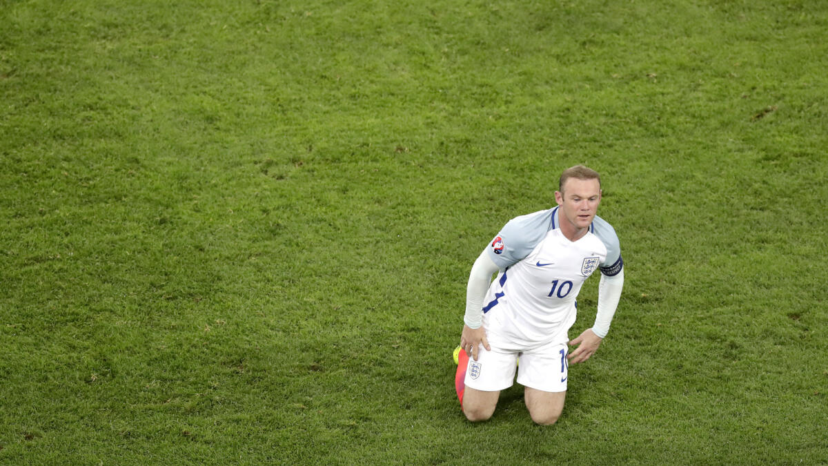 England's Wayne Rooney  kneels on the pitch during the Euro 2016 Group B soccer match between England and Russia at the Velodrome stadium in Marseille, France, Saturday, June 11, 2016.