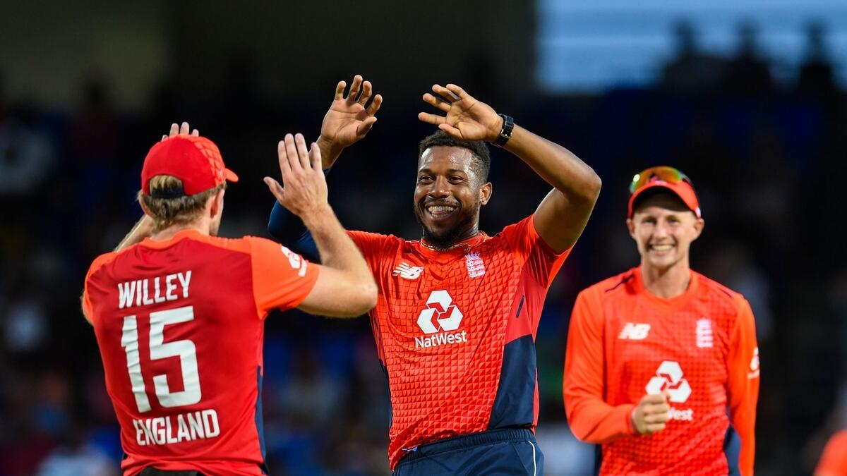 Chris Jordan (centre), David Willey (left) and Joe Root of England celebrate a wicket against the West Indies. (AFP file)