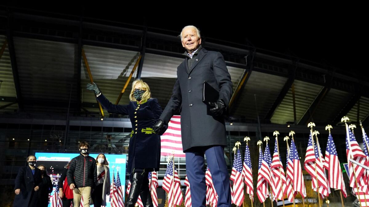 Joe Biden holds hands with his wife Jill Biden during a drive-in campaign rally at Heinz Field in Pittsburgh. Reuters