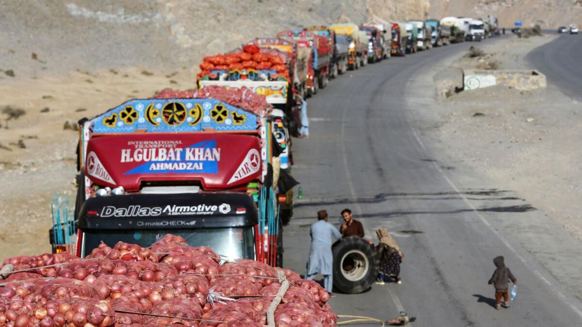 Goods carrier trucks parked along a street wait to enter Pakistan, near the Torkham border crossing between Afghanistan and Pakistan. — AFP