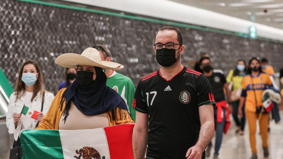 Supporters of Mexico's Tigres UANL football club, mask-clad due to the Covid-19 coronavirus pandemic, walk at a station of the Doha Metro while on the way to attend a club fan event outside Education City Stadium in the Qatari city of Ar-Rayyan. — AFP